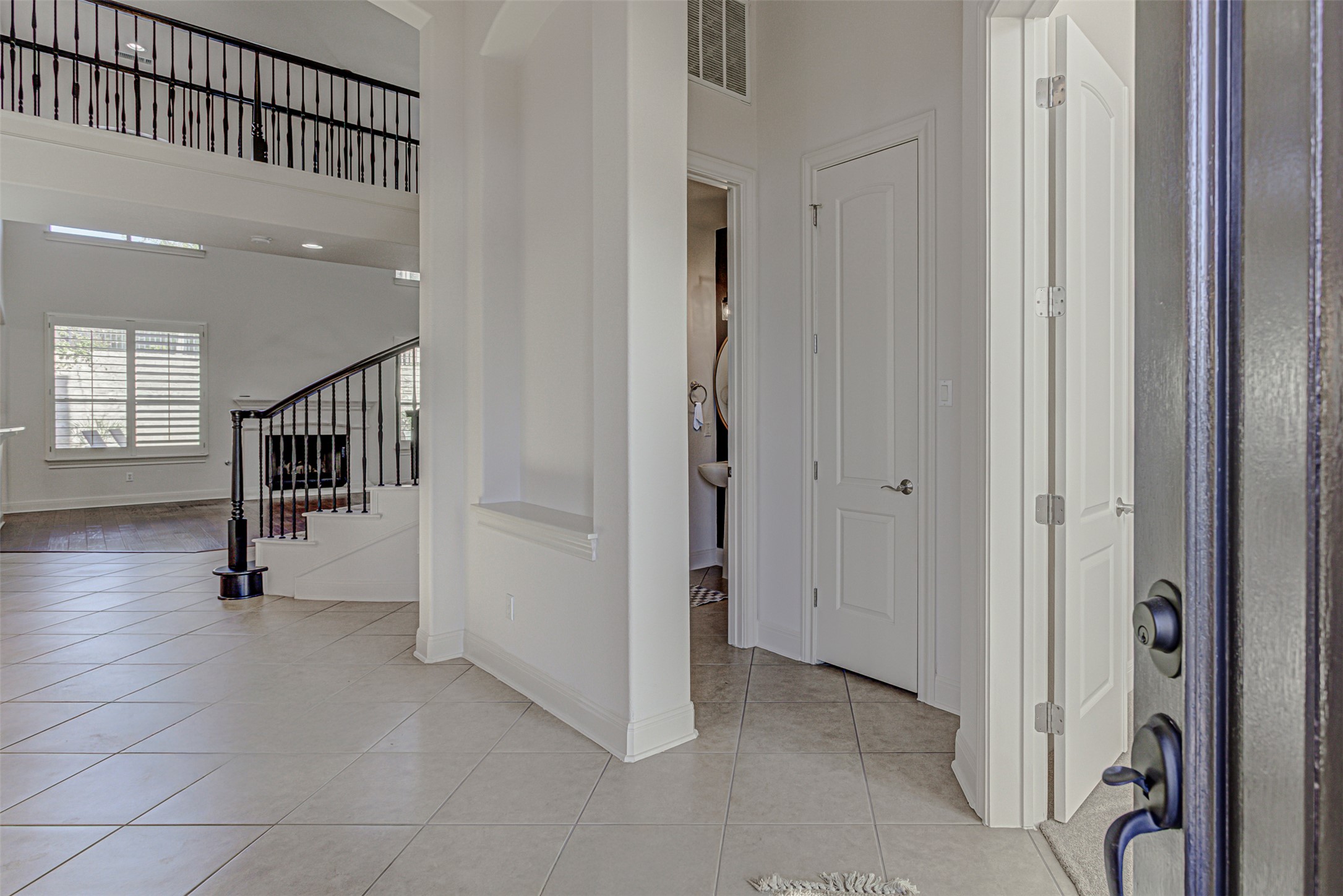110 Sebastians Run Austin, TX 78738 - Photo 7 of 40 Foyer entrance with light tile patterned flooring, stairway, and a towering ceiling