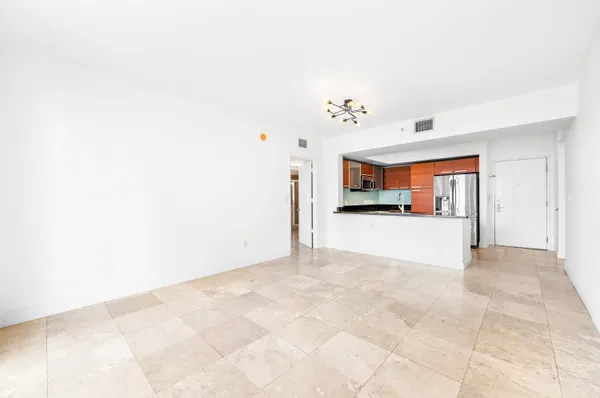 a view of a kitchen with furniture and an empty room
