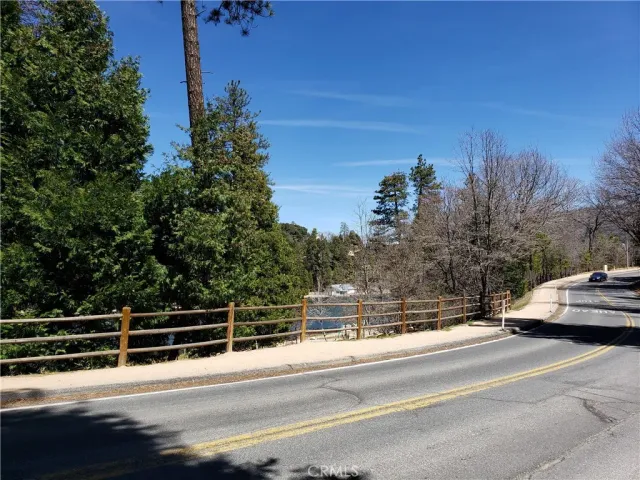 a view of a yard with snow on the road