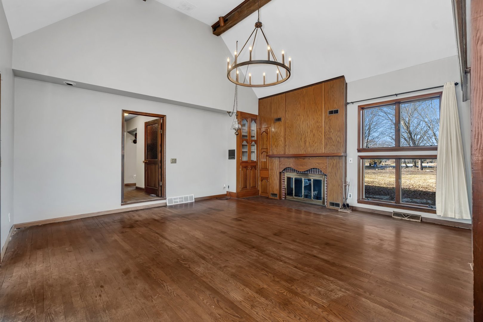 13070 McKanna Road Minooka, IL 60447 - Photo 15 of 43 a view of an empty room with wooden floor and a window