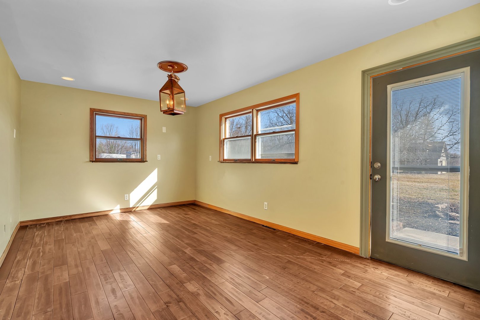 13070 McKanna Road Minooka, IL 60447 - Photo 27 of 43 a view of an empty room with wooden floor and a window