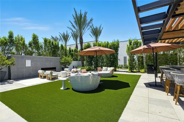 a view of backyard with outdoor seating and patio