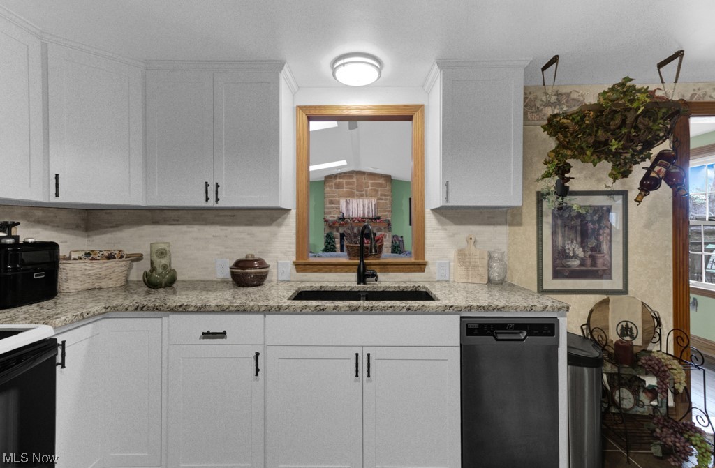 7166 Lowmiller Road Minerva, OH 44657 - Photo 9 of 35 Kitchen with stainless steel dishwasher, sink, and white cabinetry