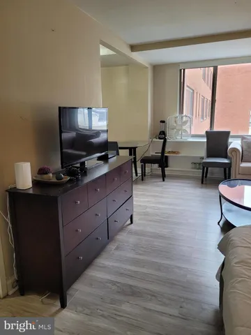 a view of a workspace with furniture and wooden floor