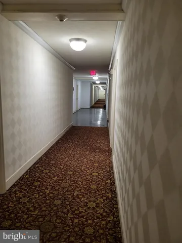 a kitchen with a table chairs and a refrigerator