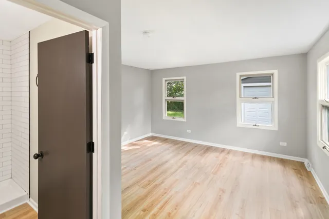an empty room with windows and closet
