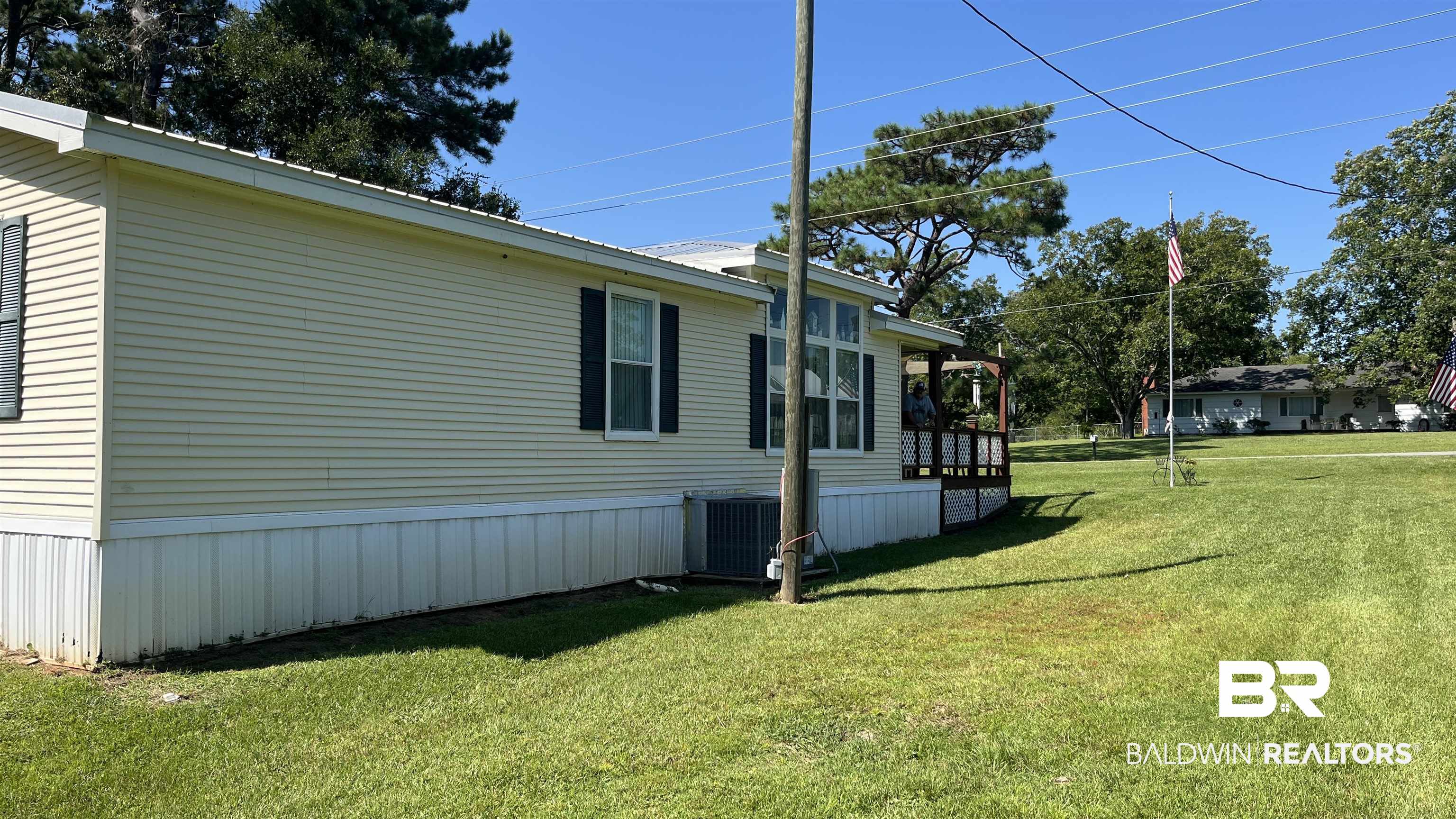 12932 Santa Piedro Street Lillian, AL 36549 - Photo 14 of 20 View of side of property featuring a yard and a sunroom