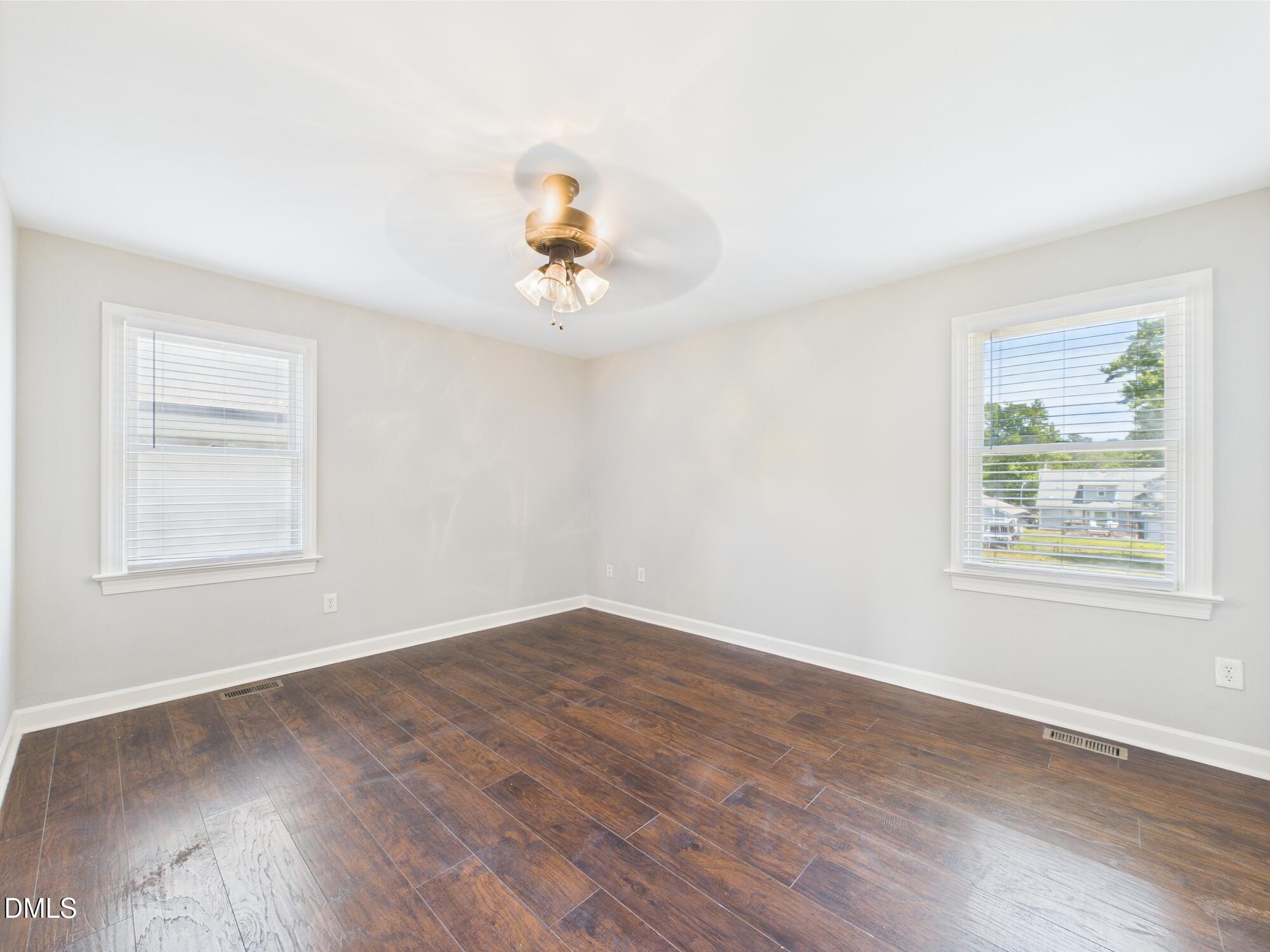 10917 Fanny Brown Road Raleigh, NC 27603 - Photo 25 of 54 a view of an empty room with a window and wooden floor