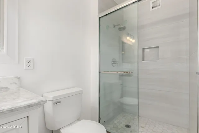 a bathroom with a shower toilet and sink