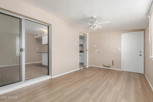 wooden floor in an empty room with a bathroom