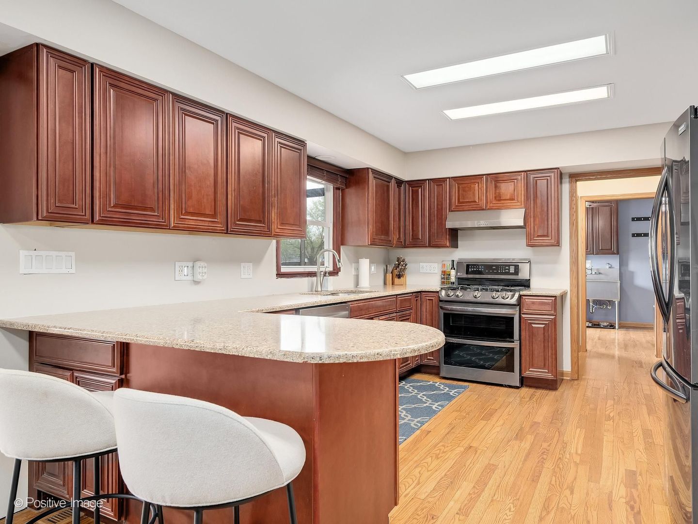 612 Stuart Drive Carol Stream, IL 60188 - Photo 9 of 29 a kitchen with stainless steel appliances granite countertop a sink a stove a refrigerator cabinets and a chairs