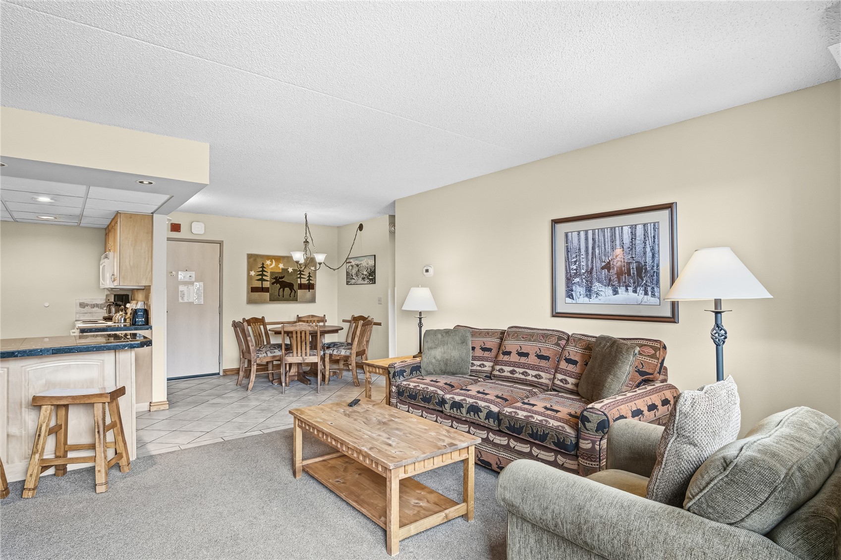 611 Village Road, Unit 24260 Breckenridge, CO 80424 - Photo 5 of 50 a living room with furniture and a dining table with kitchen view