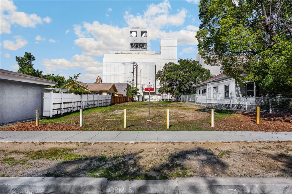 220 West C Street Ontario, CA 91762 - Photo 5 of 22 a view of a swimming pool with a lawn chairs under an umbrella