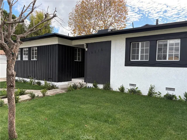 a backyard of a house with table and chairs