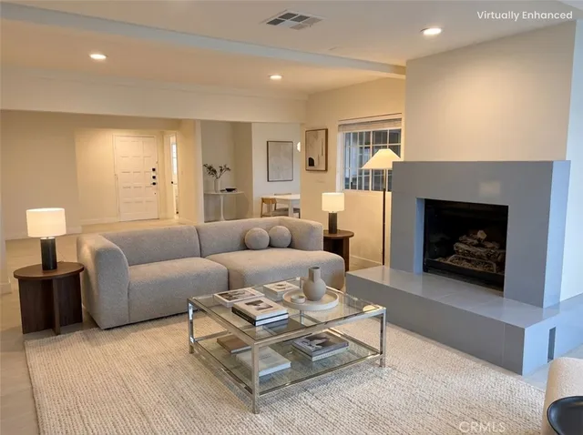 a living room with furniture a fireplace and a table