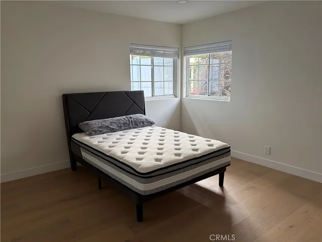 a bed sitting in a bedroom next to a window