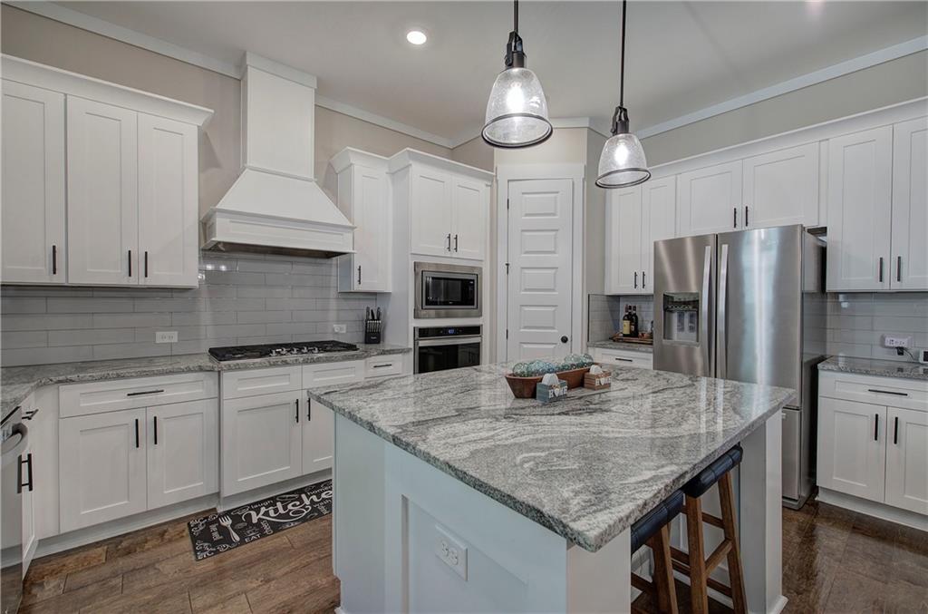 503 London Road Ball Ground, GA 30107 - Photo 12 of 55 a kitchen with stainless steel appliances granite countertop a sink refrigerator and cabinets