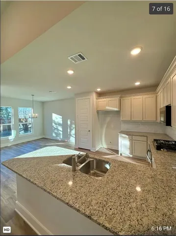 a view of a kitchen with a sink and cabinets