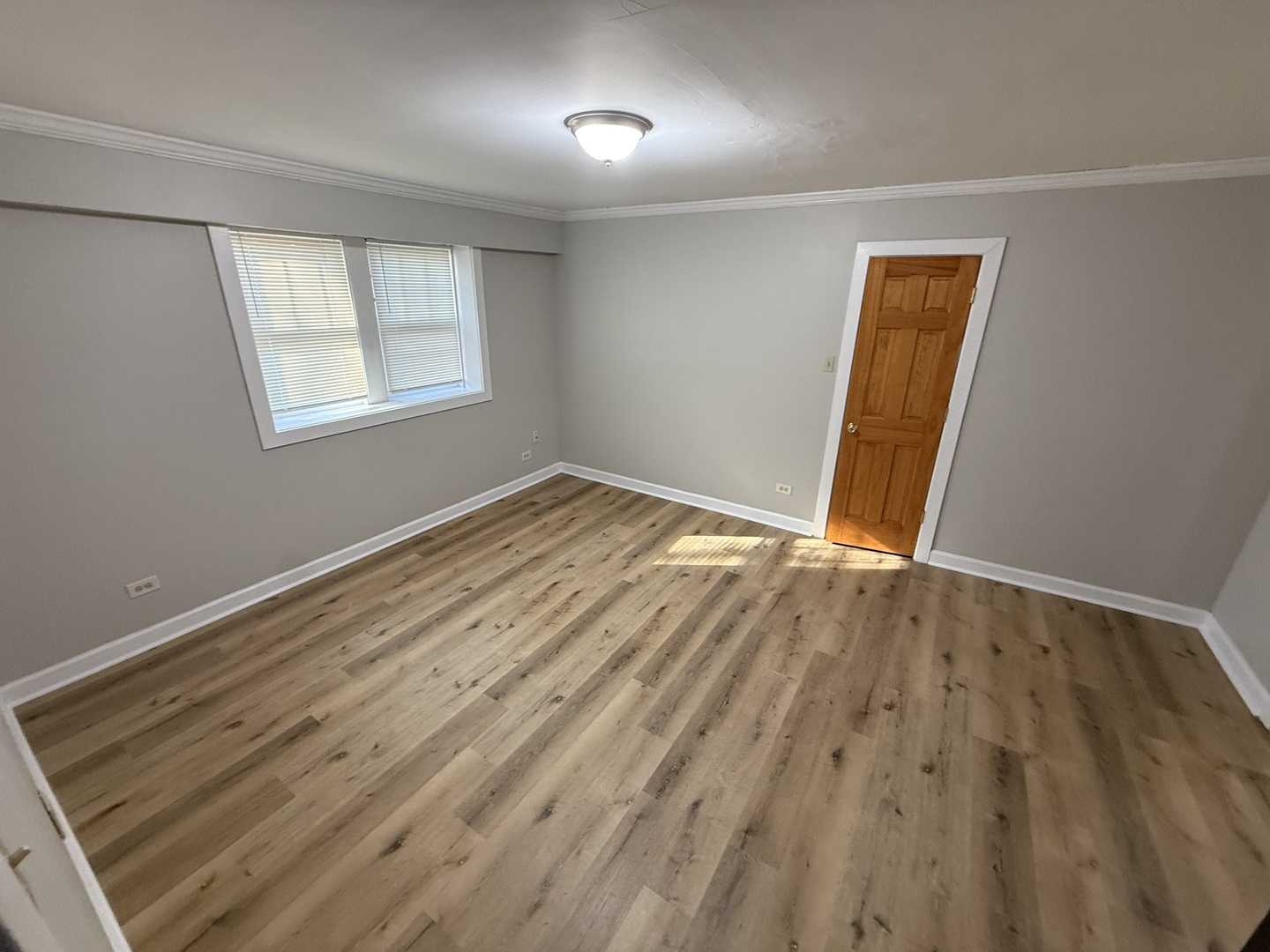 102 Lincoln Avenue, Unit GDN Riverside, IL 60546 - Photo 3 of 12 a view of an empty room with wooden floor and a window