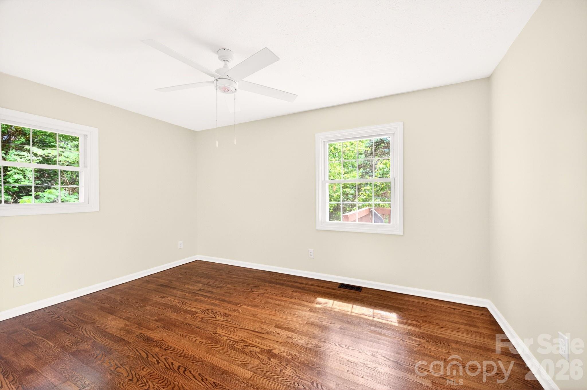 34 Wolfe Cove Road Asheville, NC 28804 - Photo 18 of 42 an empty room with a window and a ceiling fan