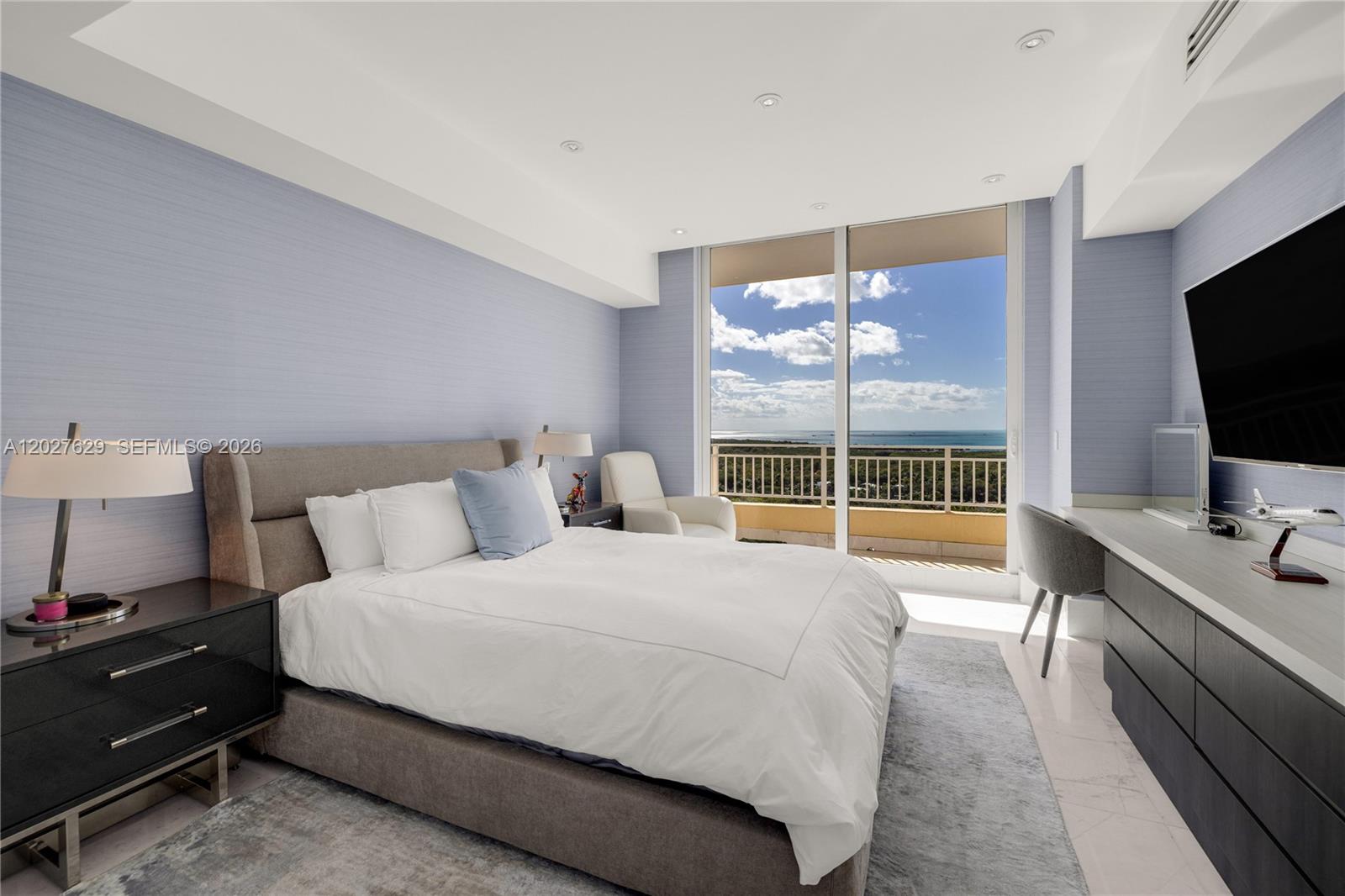 799 Crandon Boulevard, Unit PH8 Key Biscayne, FL 33149 - Photo 14 of 47 a bedroom with a bed and a flat screen tv