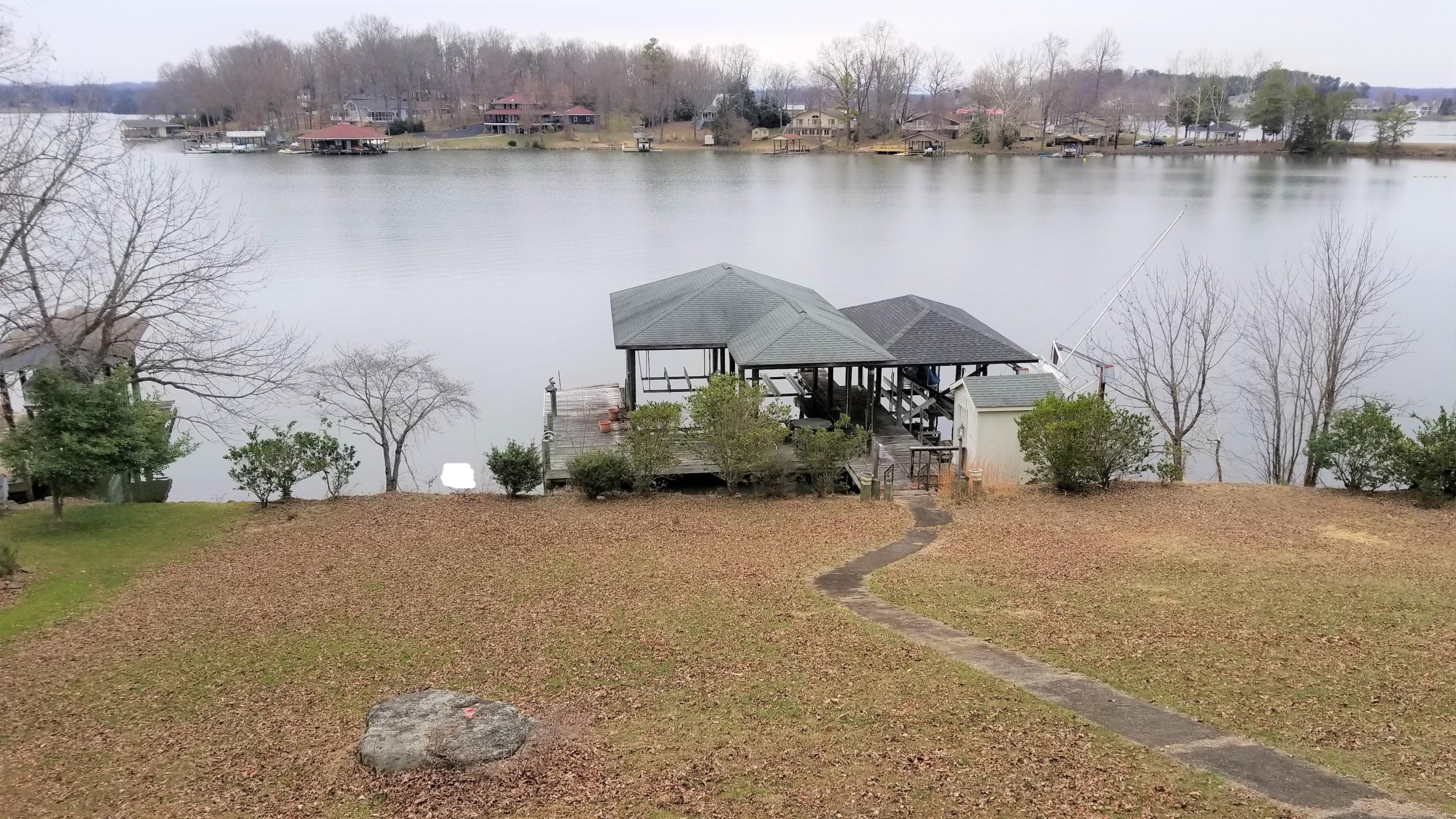 541 Highland Lake Road Union Hall, VA 24176 - Photo 2 of 37 a backyard of a house with lots of green space and lake view