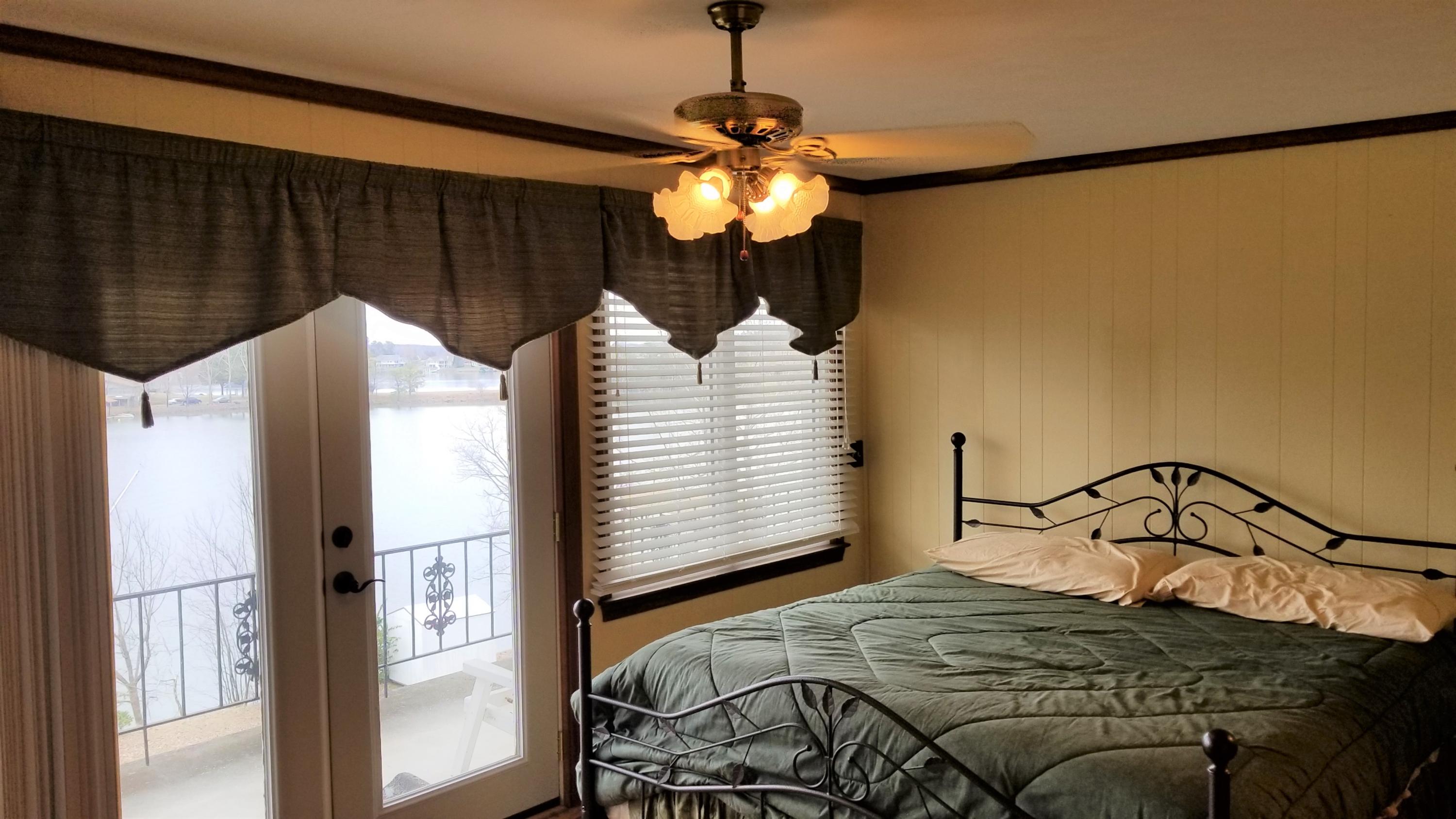 541 Highland Lake Road Union Hall, VA 24176 - Photo 11 of 37 a bedroom with a bed and a chandelier