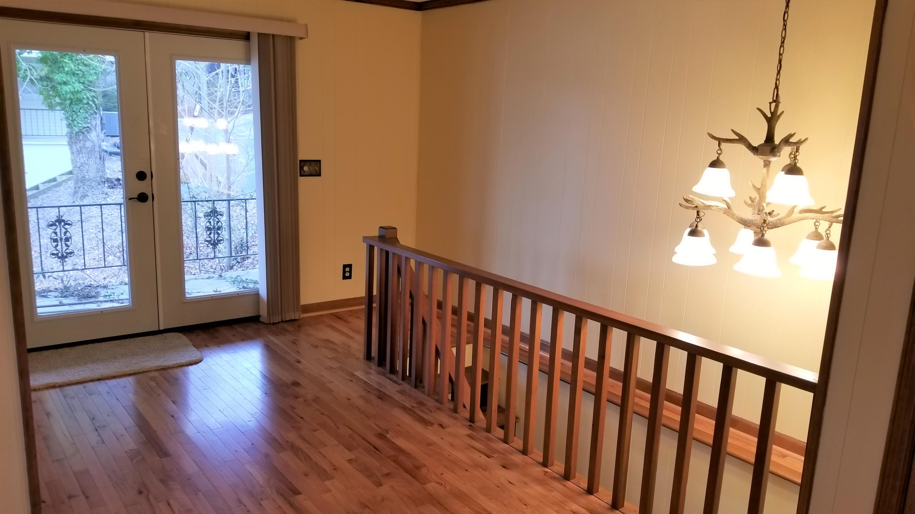 541 Highland Lake Road Union Hall, VA 24176 - Photo 17 of 37 a view of a hallway with wooden floor and stairs