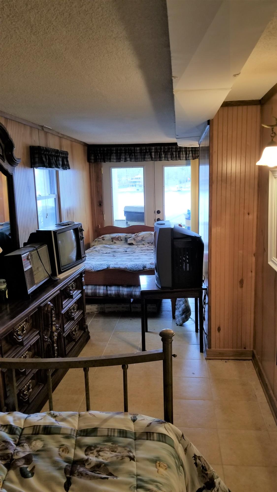 541 Highland Lake Road Union Hall, VA 24176 - Photo 21 of 37 a bedroom with a bed and wooden floor