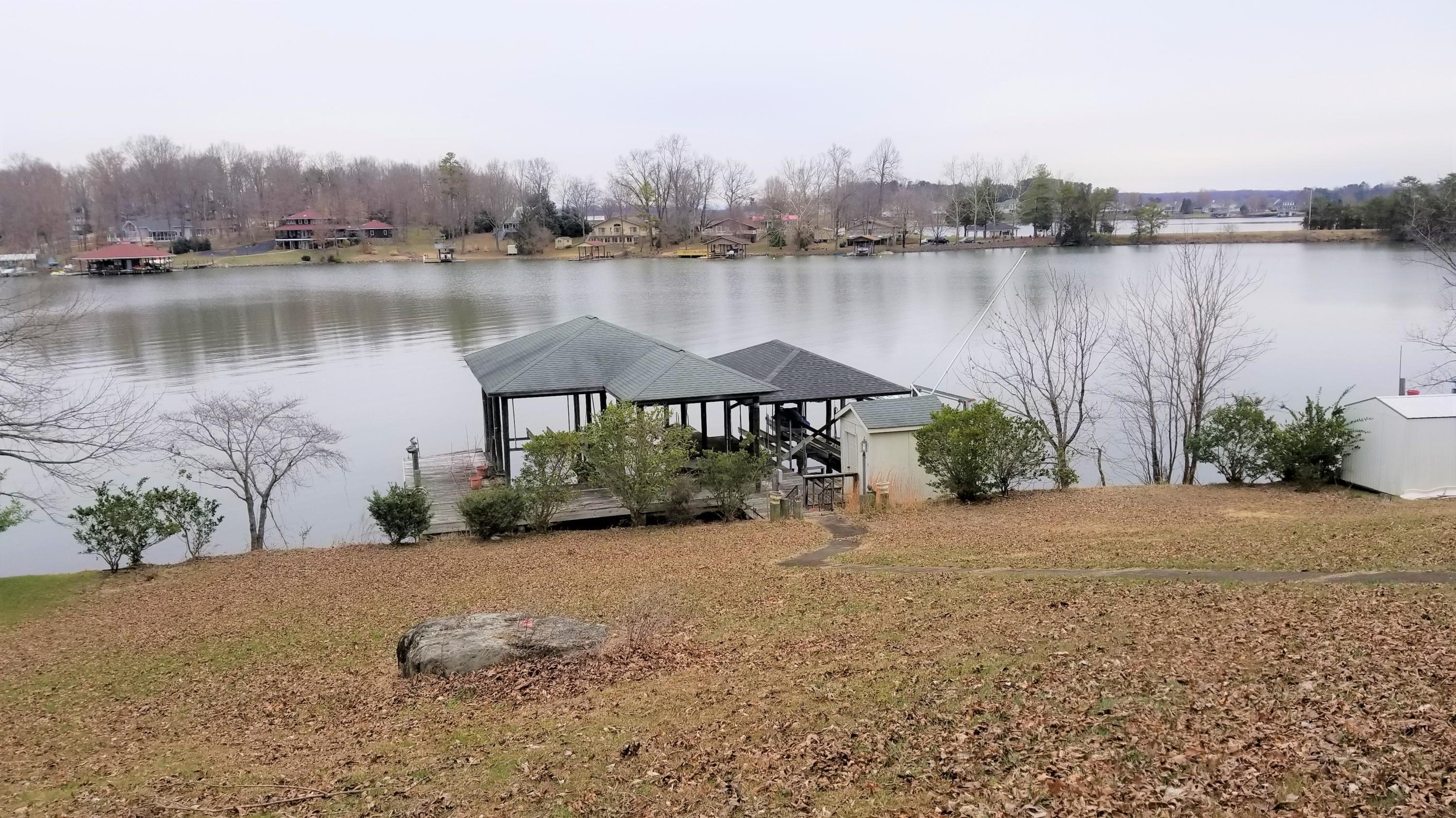 541 Highland Lake Road Union Hall, VA 24176 - Photo 27 of 37 a view of a lake with a yard and a large building