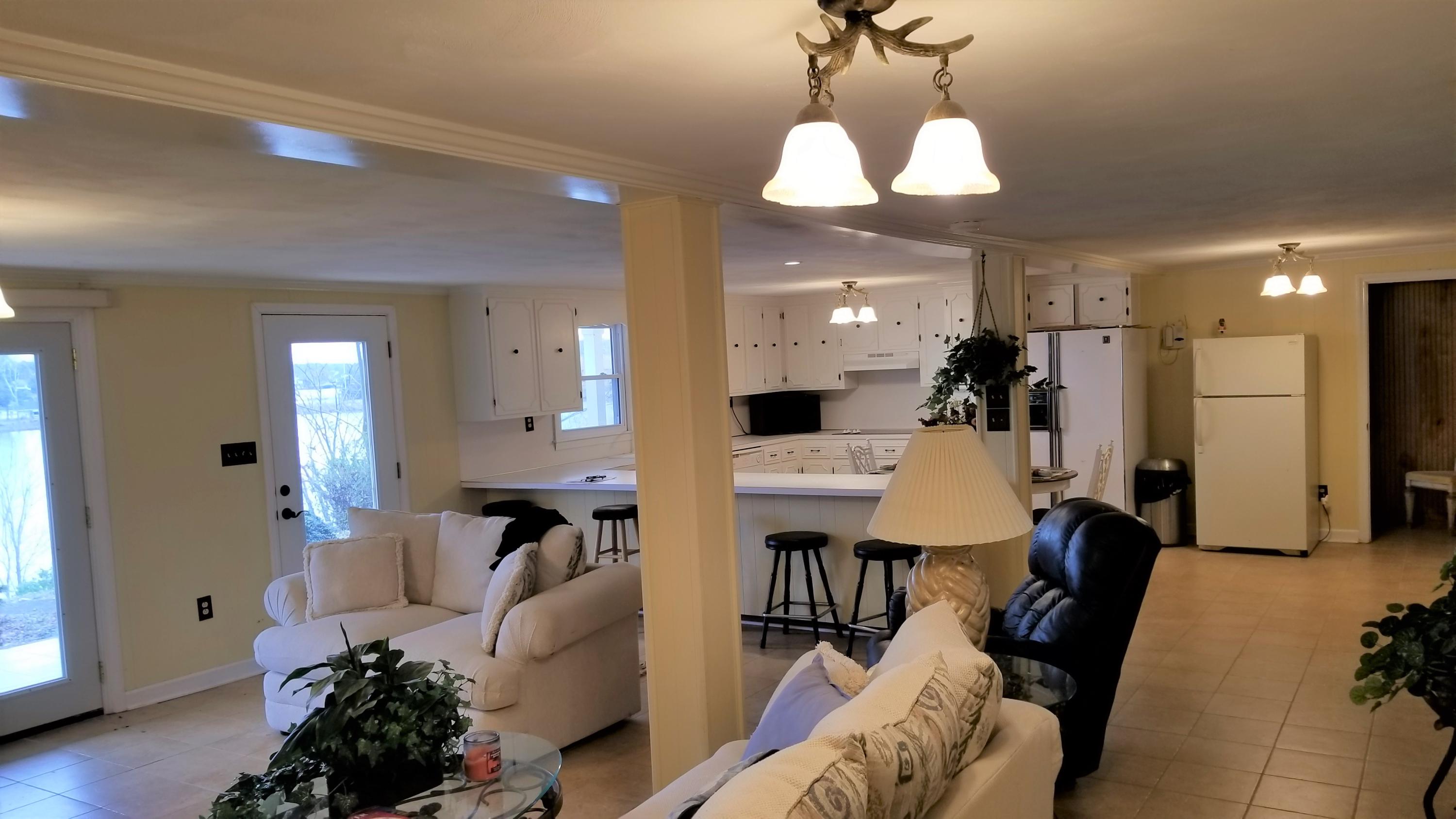 541 Highland Lake Road Union Hall, VA 24176 - Photo 6 of 37 a living room with furniture a mirror and a chandelier