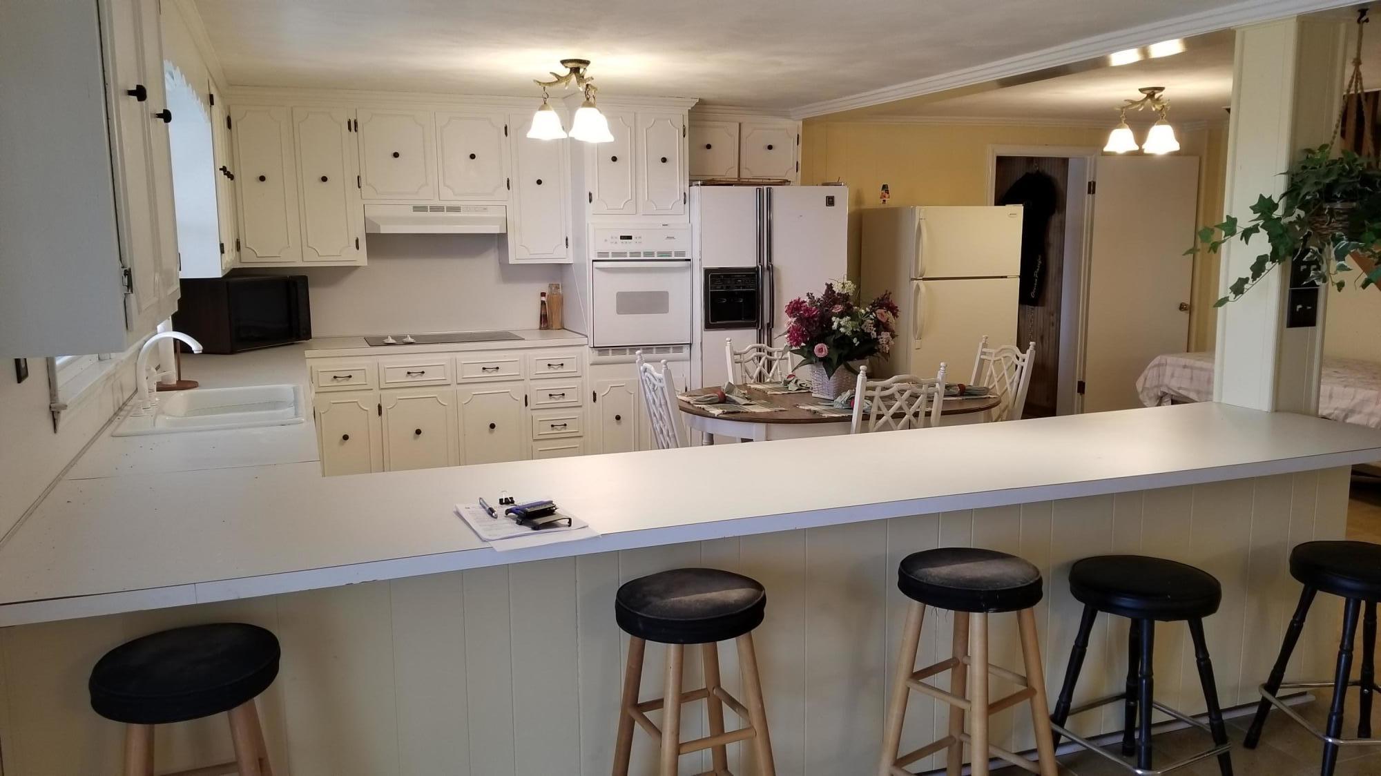 541 Highland Lake Road Union Hall, VA 24176 - Photo 7 of 37 a kitchen with cabinets and chairs