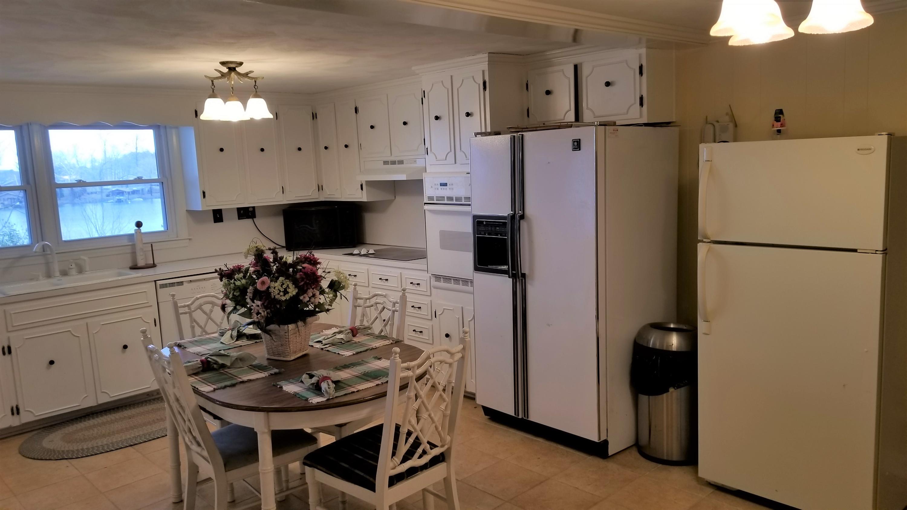 541 Highland Lake Road Union Hall, VA 24176 - Photo 9 of 37 a kitchen with stainless steel appliances a refrigerator a sink a stove a table and chairs