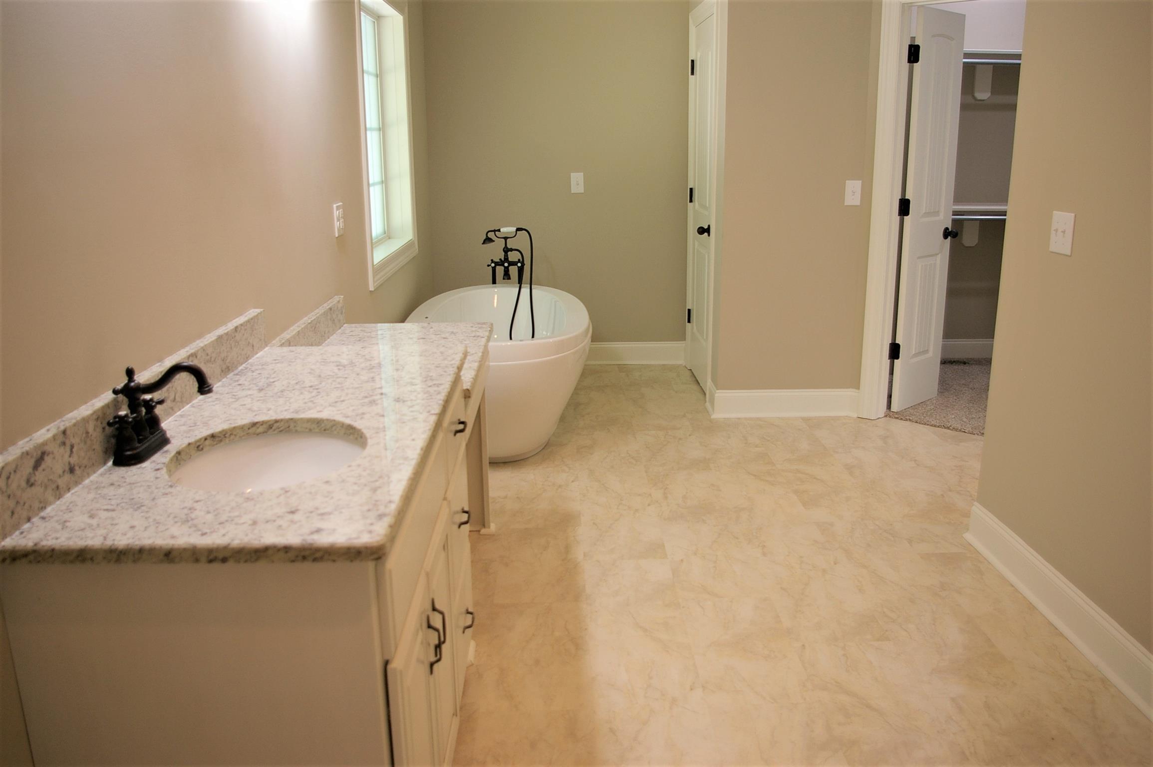 1 Sheltontown Road Manchester, TN 37355 - Photo 12 of 27 a en suite bathroom with a granite countertop sink and a tub
