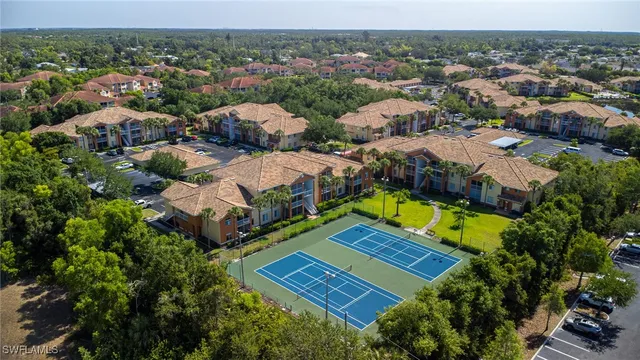 an aerial view of residential houses with yard and swimming pool