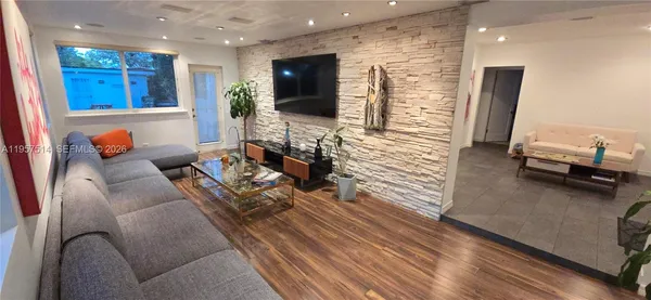 a kitchen with stainless steel appliances granite countertop a refrigerator a stove and a sink