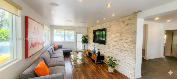 a living room with furniture and a flat screen tv