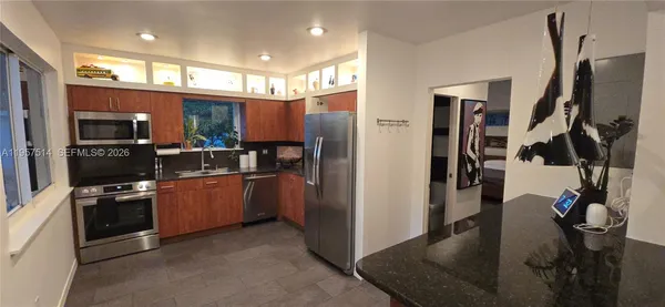 a view of a backyard with plants and trees