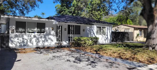 a view of a house with a yard covered in snow