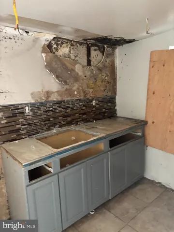 a view of a sink and dishwasher with wooden floor
