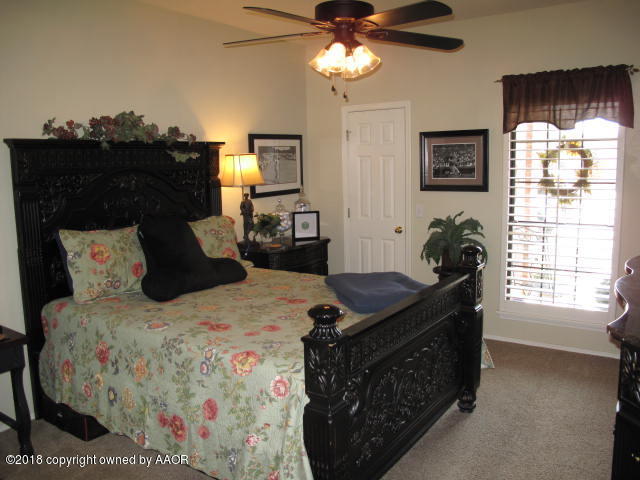 3509 West Point Drive Amarillo, TX 79121 - Photo 12 of 18 a bedroom with a bed and a window