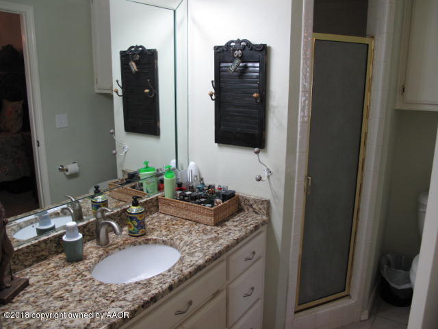 3509 West Point Drive Amarillo, TX 79121 - Photo 13 of 18 a bathroom with a granite countertop double vanity and a mirror