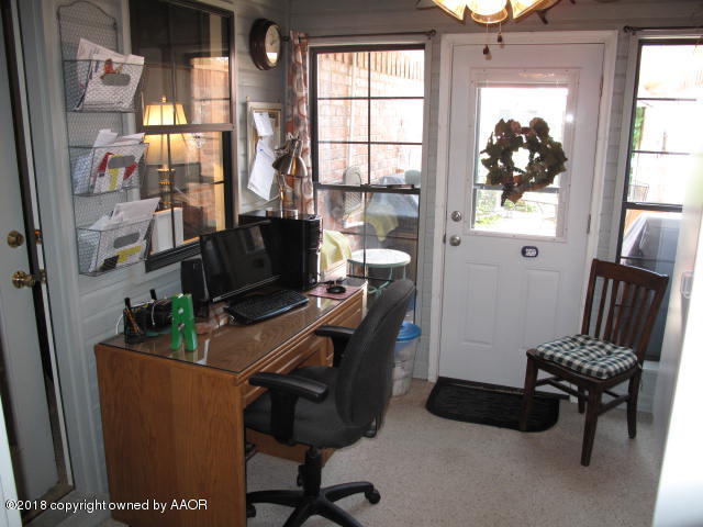 3509 West Point Drive Amarillo, TX 79121 - Photo 15 of 18 a view of a workspace with furniture and a window