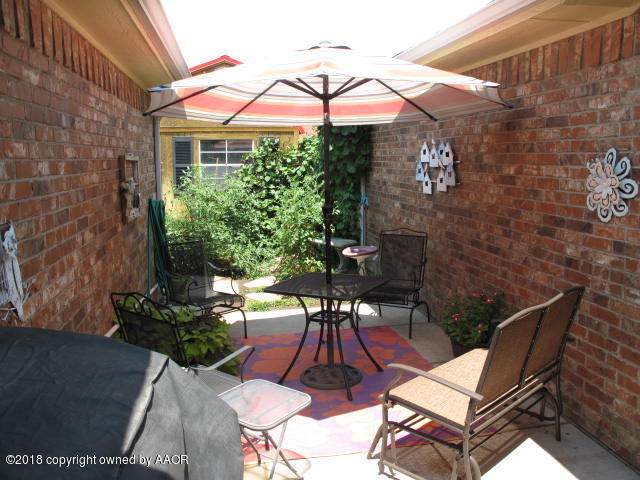 3509 West Point Drive Amarillo, TX 79121 - Photo 18 of 18 a view of a patio with table and chairs and potted plants