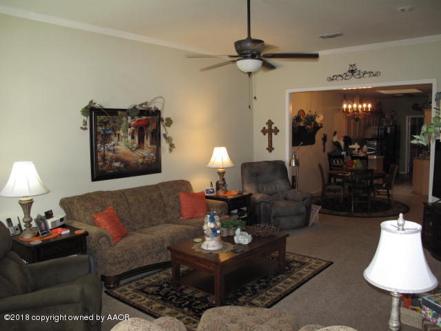 3509 West Point Drive Amarillo, TX 79121 - Photo 3 of 18 a living room with furniture and a lamp