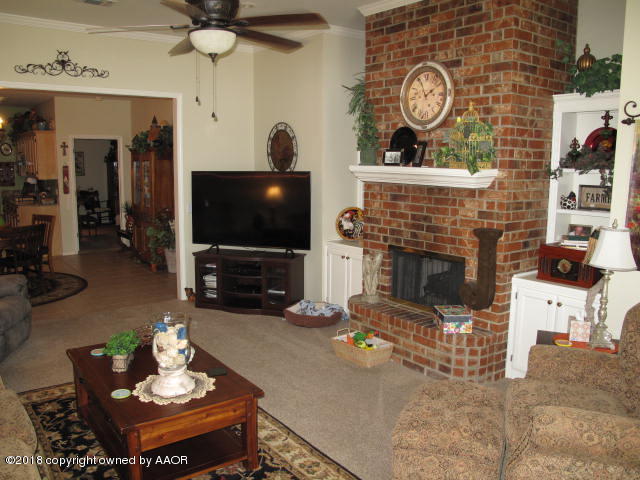 3509 West Point Drive Amarillo, TX 79121 - Photo 4 of 18 a living room with furniture a flat screen tv and a fireplace