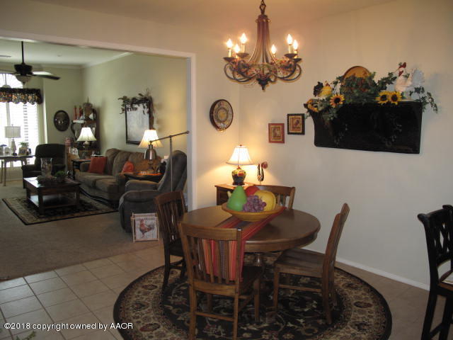 3509 West Point Drive Amarillo, TX 79121 - Photo 7 of 18 a dining room with furniture a chandelier and wooden floor
