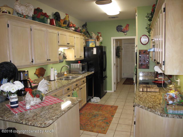 3509 West Point Drive Amarillo, TX 79121 - Photo 8 of 18 a kitchen with refrigerator and stove