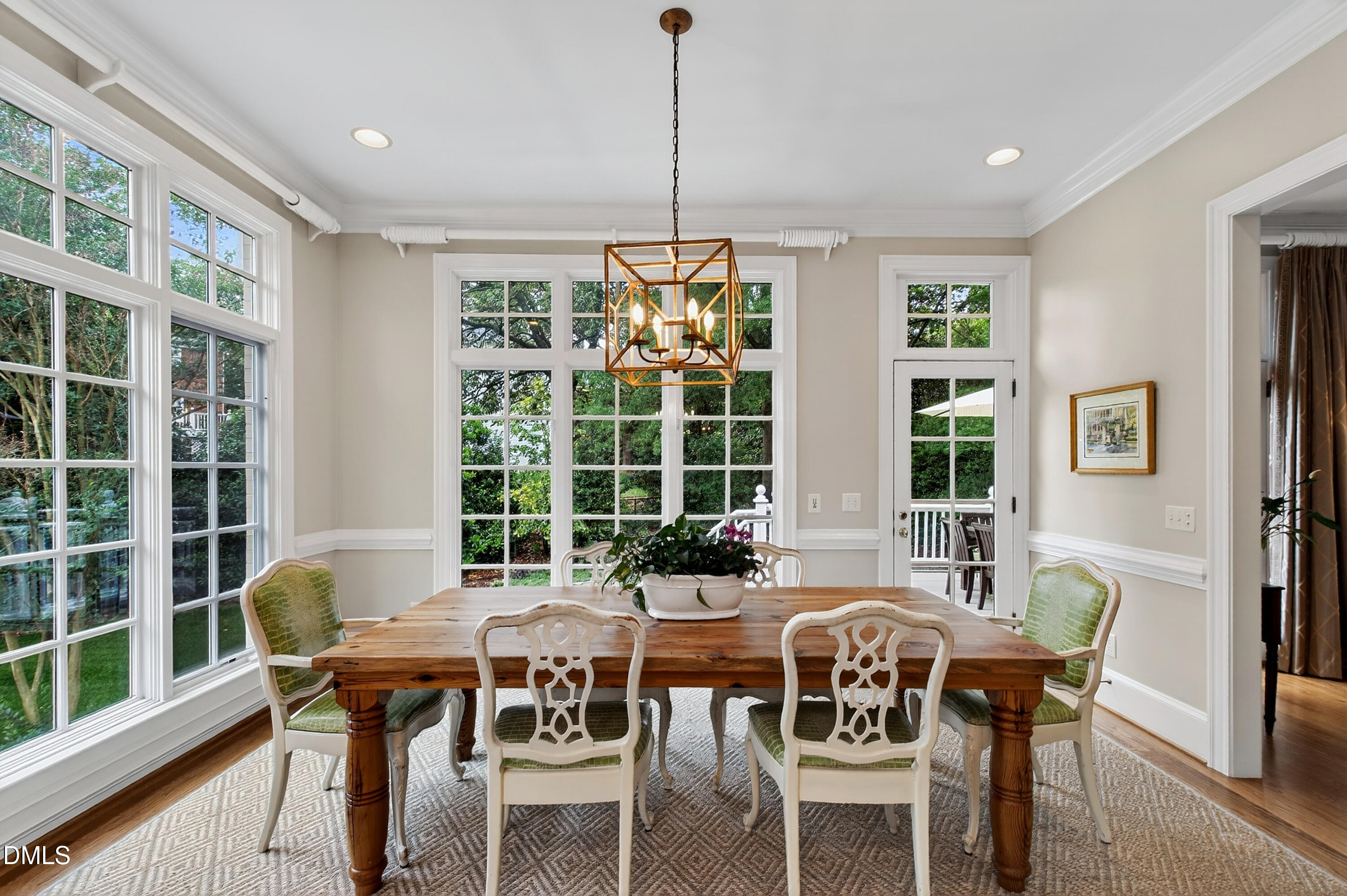 2536 Wake Drive Raleigh, NC 27608 - Photo 19 of 74 a dining room with furniture a chandelier and wooden floor