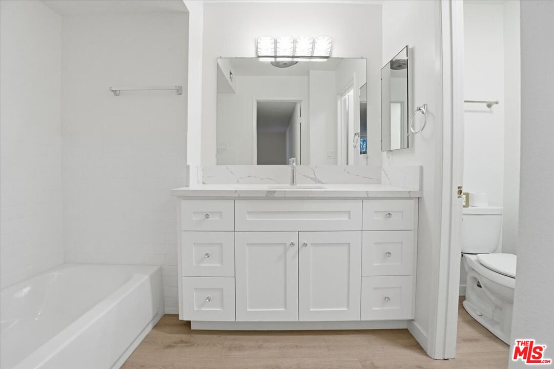 15480 Antioch Street, Unit 102 Pacific Palisades, CA 90272 - Photo 9 of 15 a bathroom with a bathtub a sink and a window